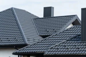 A close-up view of dark grey interlocking roof tiles featuring a modern, clean design.